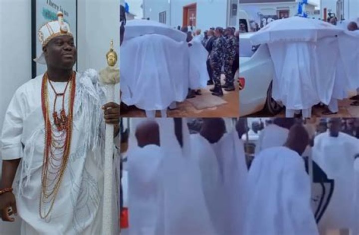 
Mixed Reactions Trail Video Of The Ooni Of Ife Being Covered By His Palace Chiefs As He Exits His Car 